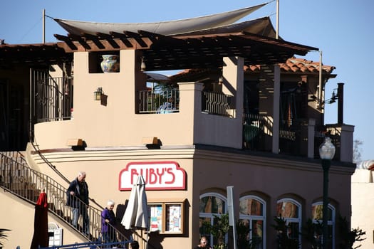 San Juan Capistrano,United States - December 25,2015: The vintage façade in adobe style of a Ruby's snack restaurant with visitors on December 25,2015 in San Juan Capistrano.