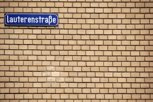 A nostalgic street sign of Lauterenstraße in Mainz on a striking brick wall.