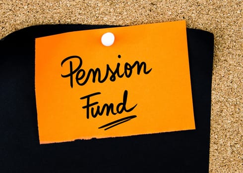 Pension Fund written on orange paper note pinned on cork board with white thumbtacks, copy space available