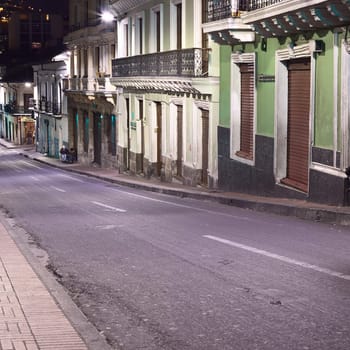 QUITO, ECUADOR - AUGUST 8, 2014: Venezuela street in the historic city center photographed at night on August 8, 2014 in Quito, Ecuador. Quito is an UNESCO World Cultural Heritage Site.
