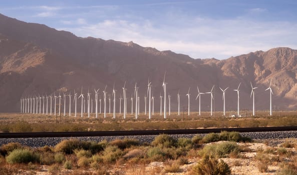 Wind turbines generate energy that goes across the mountains to LA