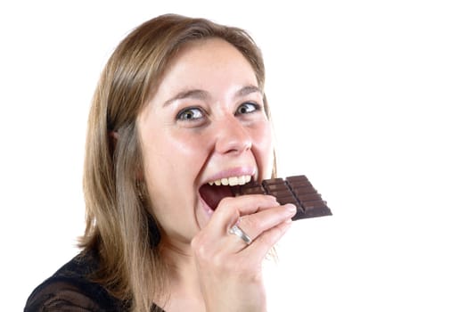 young woman eating chocolate on white background