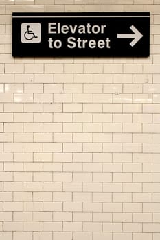 New York City Station subway directional sign on tile wall. The NYC Subway is one of the oldest and most extensive public transportation systems in the world, with 468 stations.