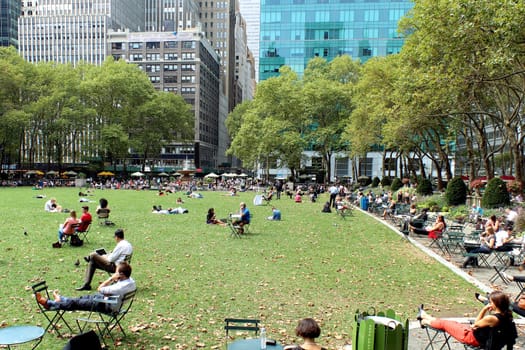 NEW YORK -SEPTEMBER 03: People enjoying at lunch time in Bryant Park on September 03, 2013 in New York City, NY. Bryant Park is a 9,603 acre privately managed park in the center of Manhattan