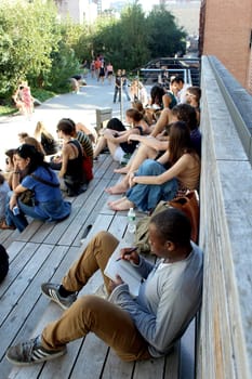 NEW YORK CITY - SEPTEMBER 03: People at High Line Park in NYC on September 03th, 2013. The High Line is a public park built on an historic freight rail line elevated above the streets on Manhattan West Side.