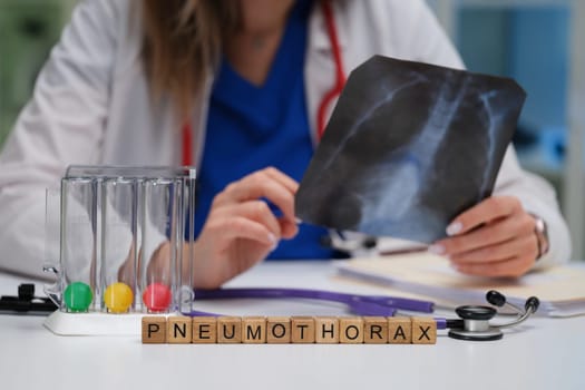 In a clinical setting, a healthcare professional carefully examines an Xray for signs indicative of pneumothorax
