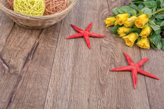 Red starfishes and orange yellow on a wooden background