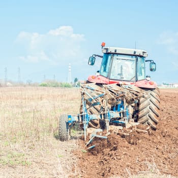 Agricultural work.  Tractor plowing the stubble field
