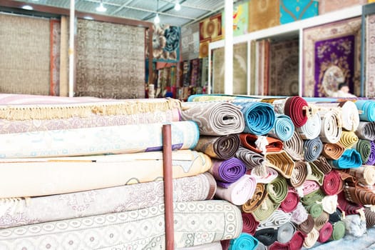 Many colorful carpets for sale  in the store.