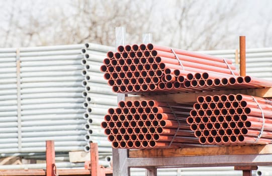 Stack of steel pipes for scaffolding in warehouse