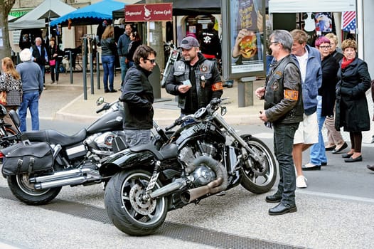 Bikers in discussion with a gathering of American motorcycles in Beaucaire in the French department of Gard
