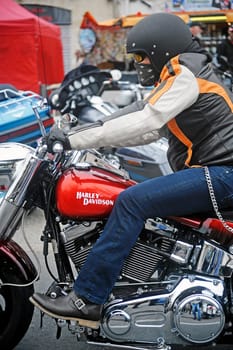 moving biker on a Harley Davidson with custom art to a gathering of American motorcycles in Beaucaire in the French department of Gard