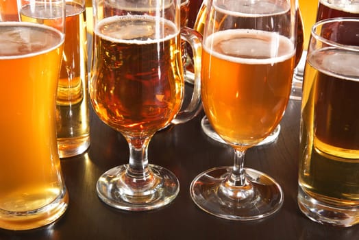 Many different beer glasses with different beer from all over the world