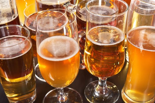 Many different beer glasses with different beer from all over the world