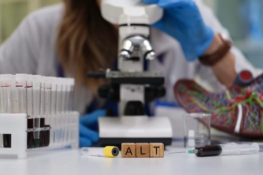 A dedicated researcher meticulously examines blood samples under a microscope, highlighting the importance of analysis