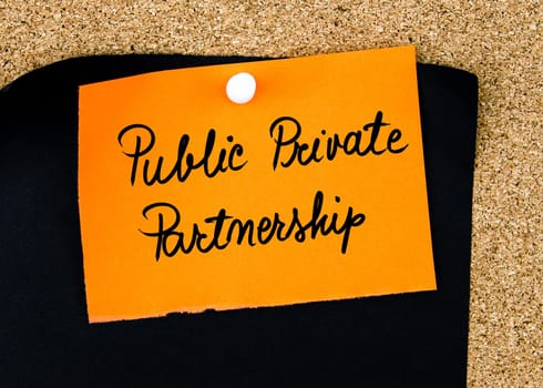 Public Private Partnership written on orange paper note pinned on cork board with white thumbtacks, copy space available