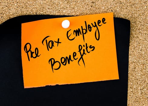 Pre Tax Employee Benefits  written on orange paper note pinned on cork board with white thumbtacks, copy space available