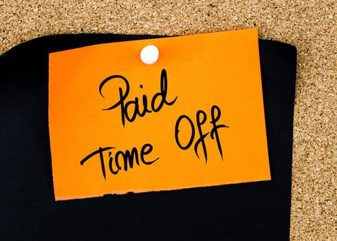 Paid Time Off written on orange paper note pinned on cork board with white thumbtacks, copy space available