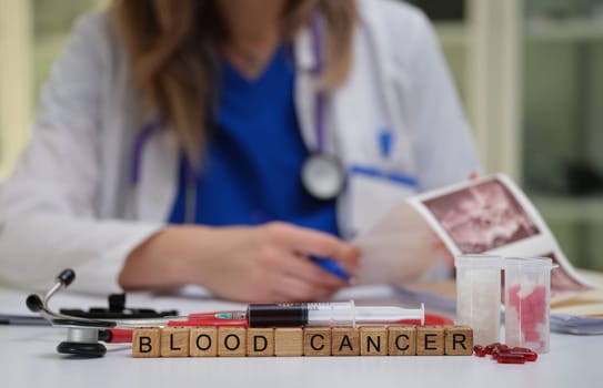 A healthcare professional examines blood cancer samples and documents everything, clearly highlighting the diagnosis