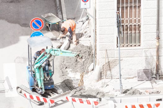 Sidewalk under construction, curb and gutter installation in progress  Construction workers.