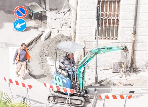 Sidewalk under construction, curb and gutter installation in progress  Construction workers.