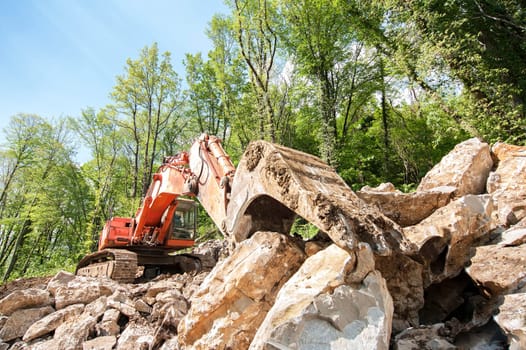 Excavator with big shovel to work with rocks