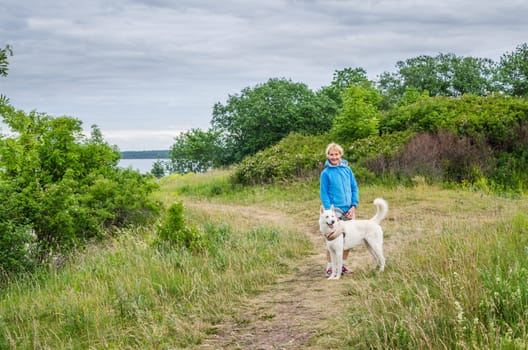 A woman with a dog on the beach