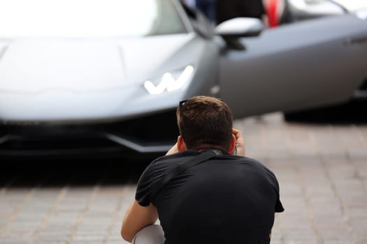 Professional Photographer Takes a Picture of a Beautiful Italian Supercar