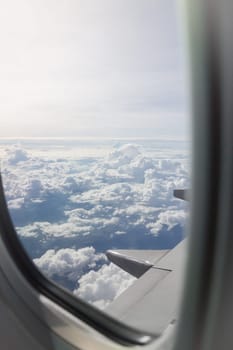 Cloudy sky view from airplane cabin window, stock photo