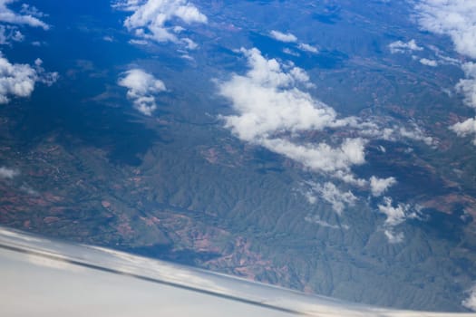 Cloudy sky view from airplane cabin window, stock photo