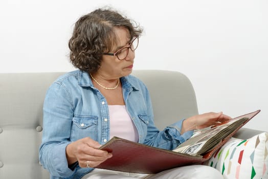 a middle-aged woman looking at photo album