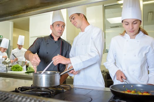 Chef advising cookery student