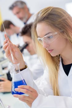 Yound lady holding erlenmeyer flask
