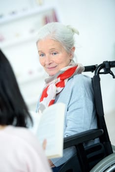 Helping senior woman to read