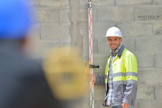 Surveyor and colleague working on site
