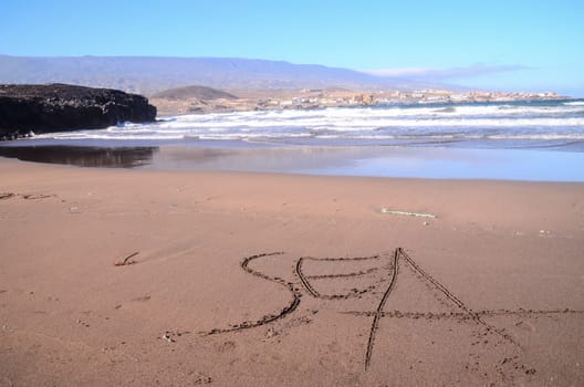 Word Written on the Sand of a Tropical beach