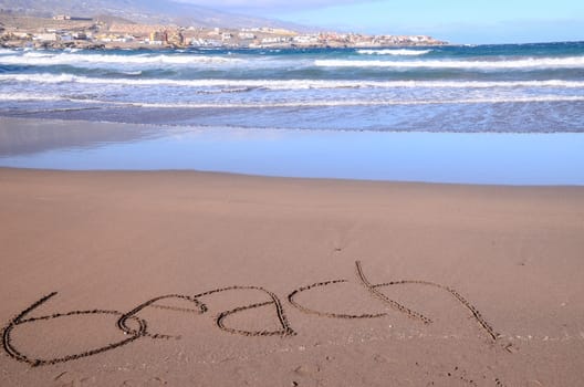 Word Written on the Sand of a Tropical beach