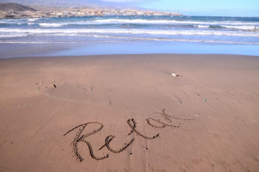 Word Written on the Sand of a Tropical beach