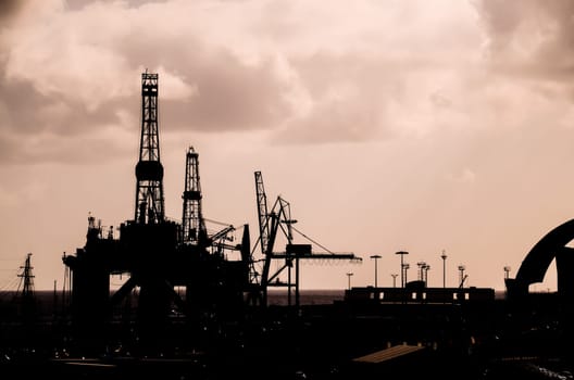 Oil Drilling Rig Silhouette over a Cloudy Sky