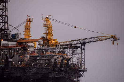 Oil Drilling Rig Silhouette over a Cloudy Sky
