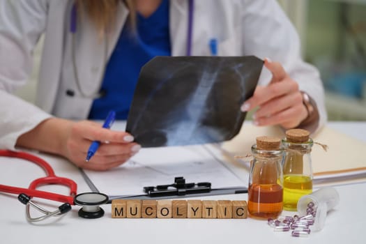 A healthcare professional conducts a detailed evaluation of an Xray while considering various mucolytic options