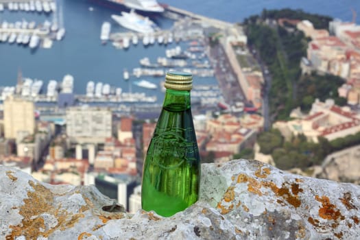 La Turbie, France - June 1, 2016: Perrier Sparkling Natural Mineral Water. Aerial View of the Port Hercule in Monaco in the Background.
