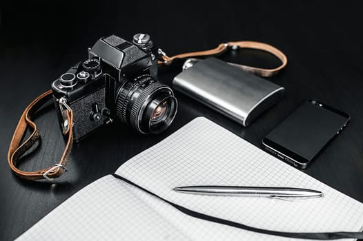 Retro Camera With Notebook On Dark Background