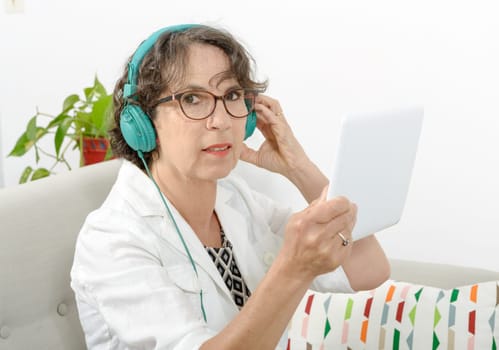 a beautiful mature woman listening to music with headphones