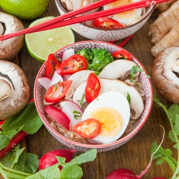 Asian noodle soup with fresh vegetables and boiled egg