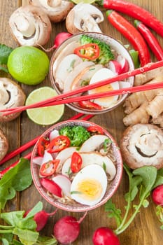 Asian noodle soup with fresh vegetables and boiled egg