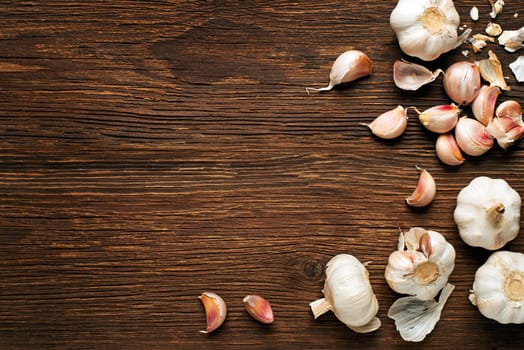Garlic cloves on a vintage wooden background.