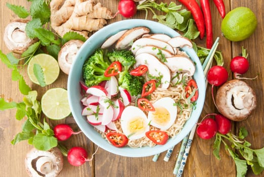 Asian noodle soup with fresh vegetables and boiled egg