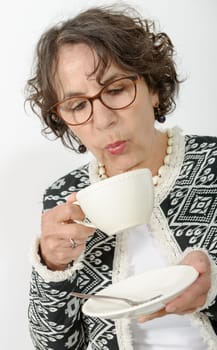 a beautiful mature woman drinking tea