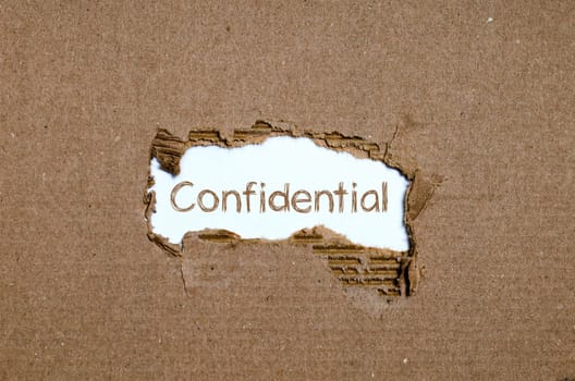 The word Confidential appearing behind torn paper.